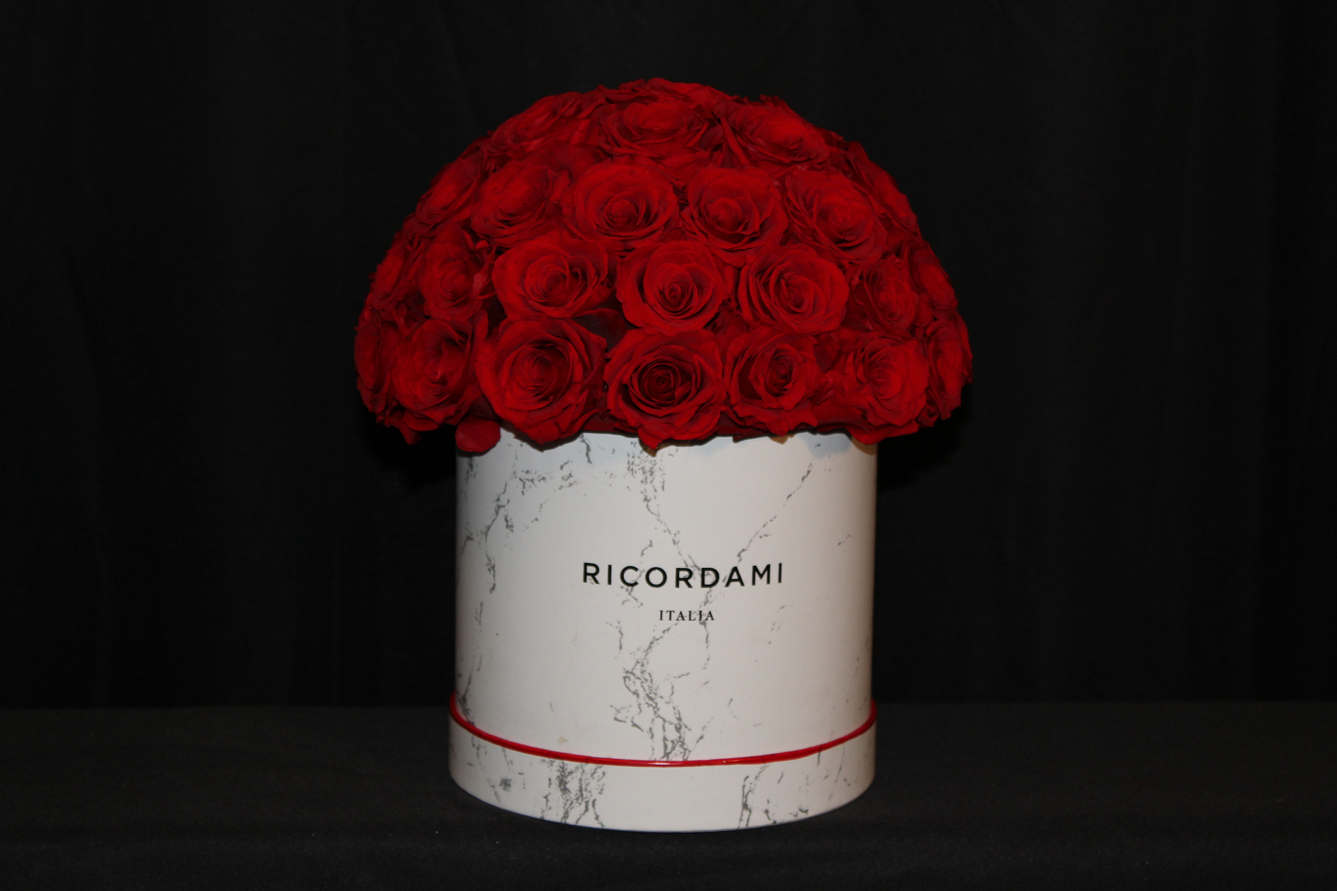 Actual Lucky Findings preserved red roses in a marble-pattern container