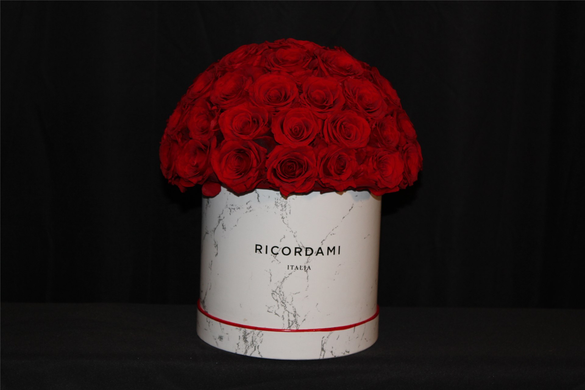 Our actual preserved red rose bouquet in a Ricordami marble-look container